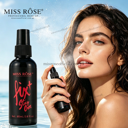 Miss Rose Fix Stay On hair spray bottle shown next to a woman holding the spray bottle, with water droplets in the air and a blue water/sky background. The Miss Rose brand logo is visible in the top left.